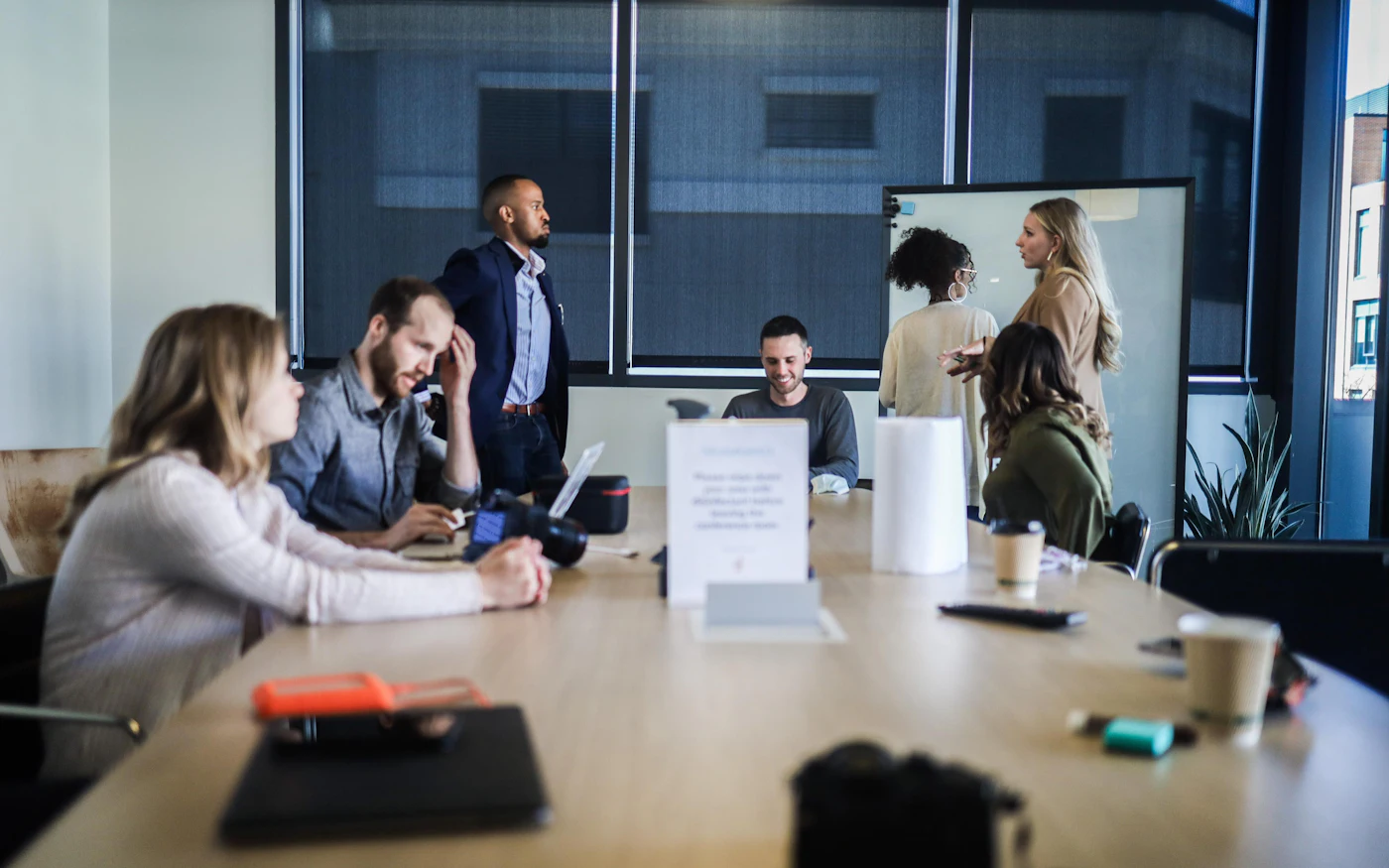 Colleagues mid-discussion around a boardroom table.